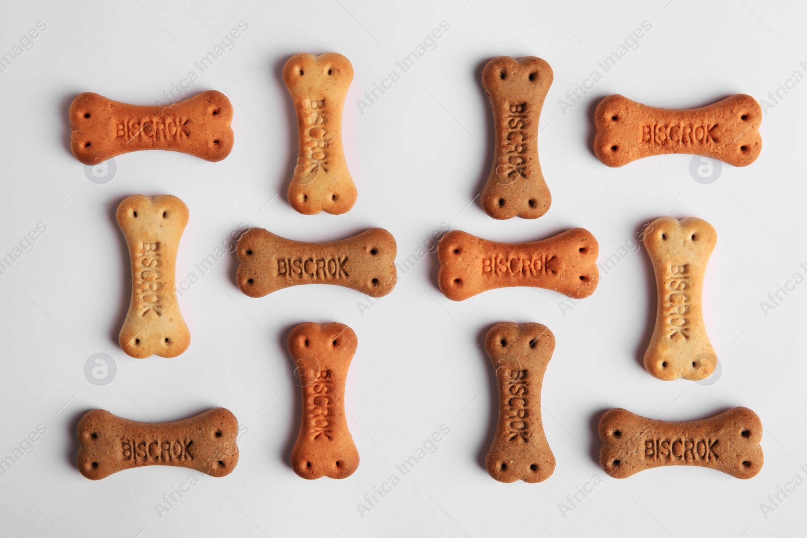 Photo of Bone shaped dog cookies on white background, top view