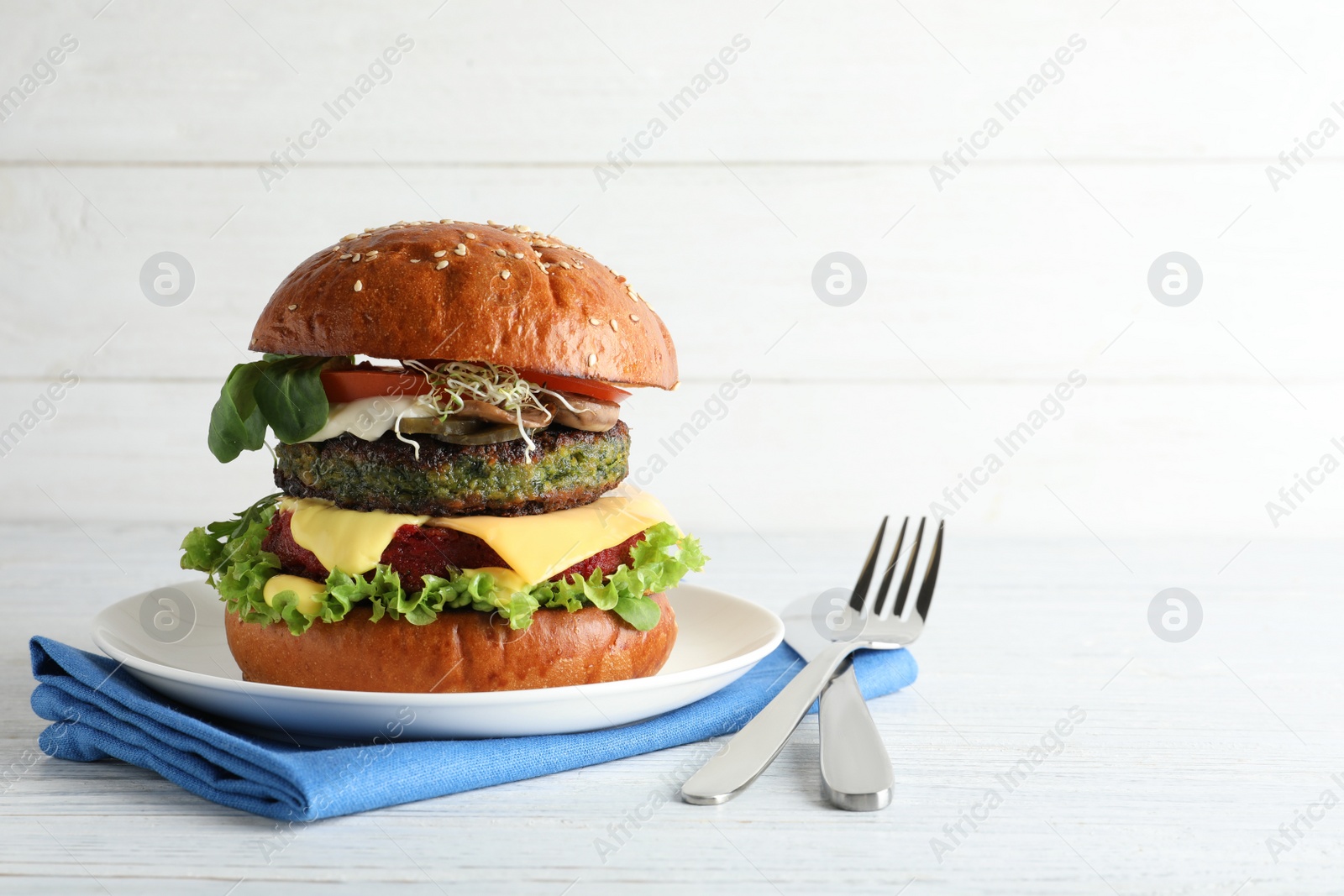 Photo of Vegan burger with beet and falafel patties served on white table. Space for text