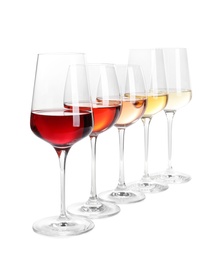 Photo of Row of glasses with different wines on white background