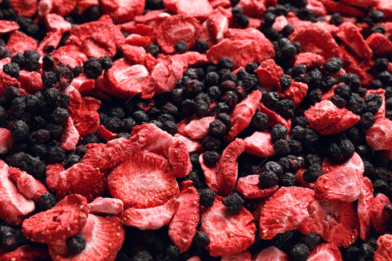 Photo of Closeup of freeze dried blueberries and strawberries as background