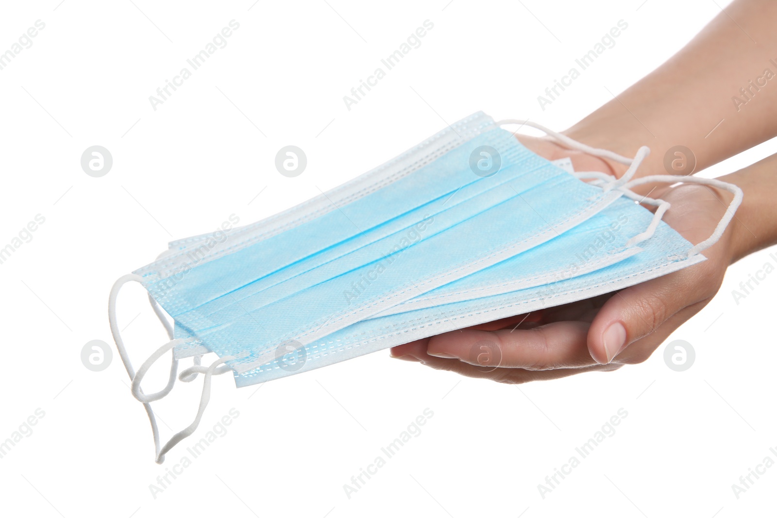 Photo of Woman holding disposable face masks on white background, closeup. Protective measures during coronavirus quarantine
