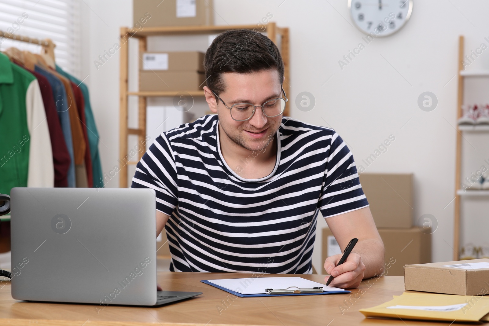 Photo of Seller with laptop working in office. Online store