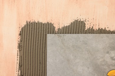 Photo of Tile and adhesive mix on wall, closeup
