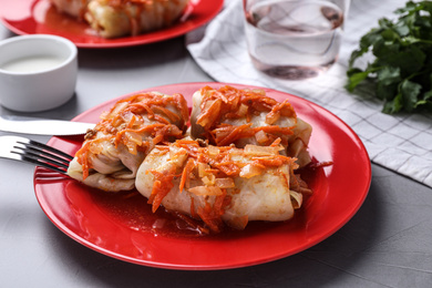 Photo of Delicious cabbage rolls served on grey table