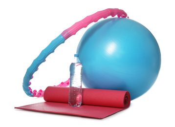 Fitness ball, yoga mat, bottle of water and hula hoop isolated on white