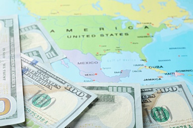 Pile of dollars near USA on world map