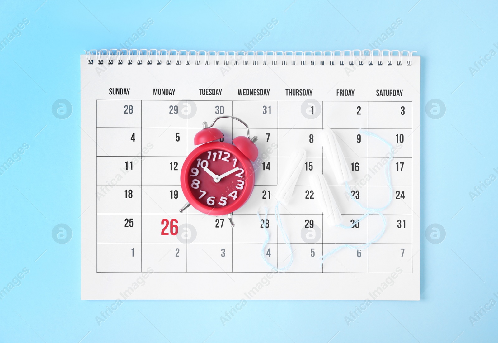 Photo of Flat lay composition with calendar, tampons and clock on blue background. Gynecology concept