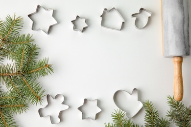 Flat lay composition with cutters for Christmas cookies on white background, top view