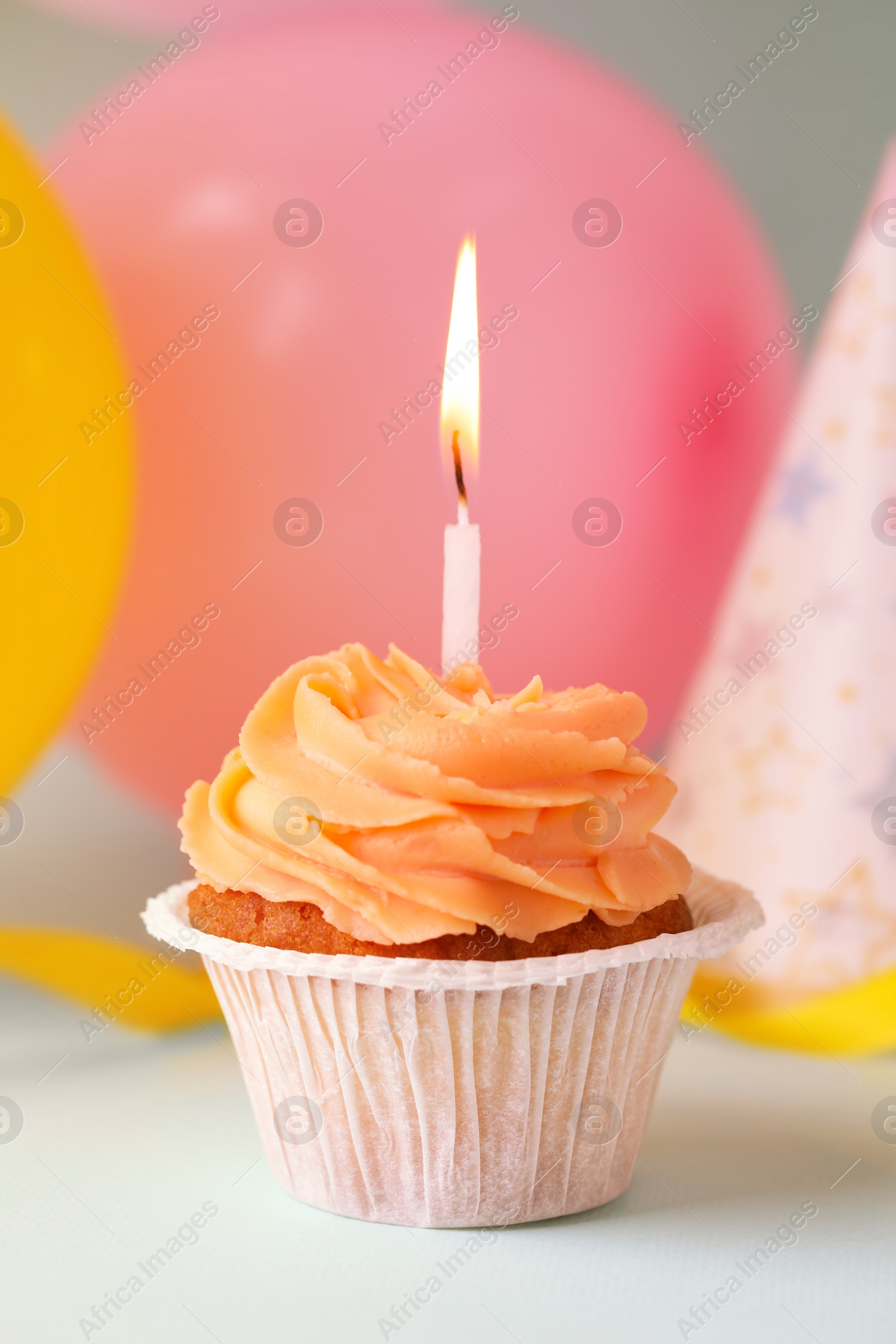 Photo of Tasty birthday cupcake with candle on light blue table, closeup