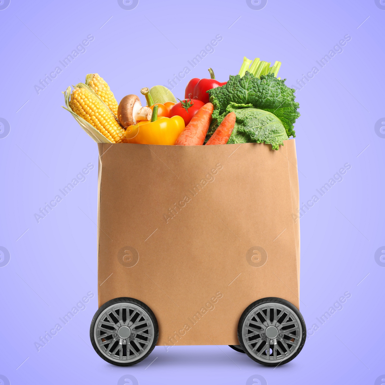 Image of Paper shopping bag full of products on wheels against violet background. Food delivery service