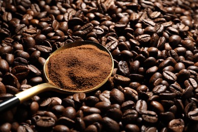Photo of Spoon with ground coffee on roasted beans, closeup. Space for text