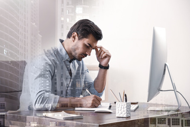 Image of Double exposure of architect working at table and buildings