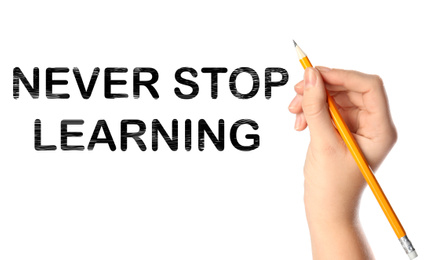 Image of Woman writing phrase NEVER STOP LEARNING on white background, closeup. Banner design
