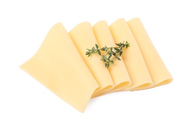 Slices of tasty fresh cheese and thyme isolated on white, top view