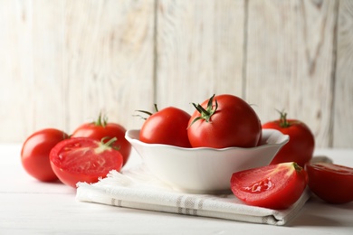 Photo of Fresh ripe tomatoes on white wooden table