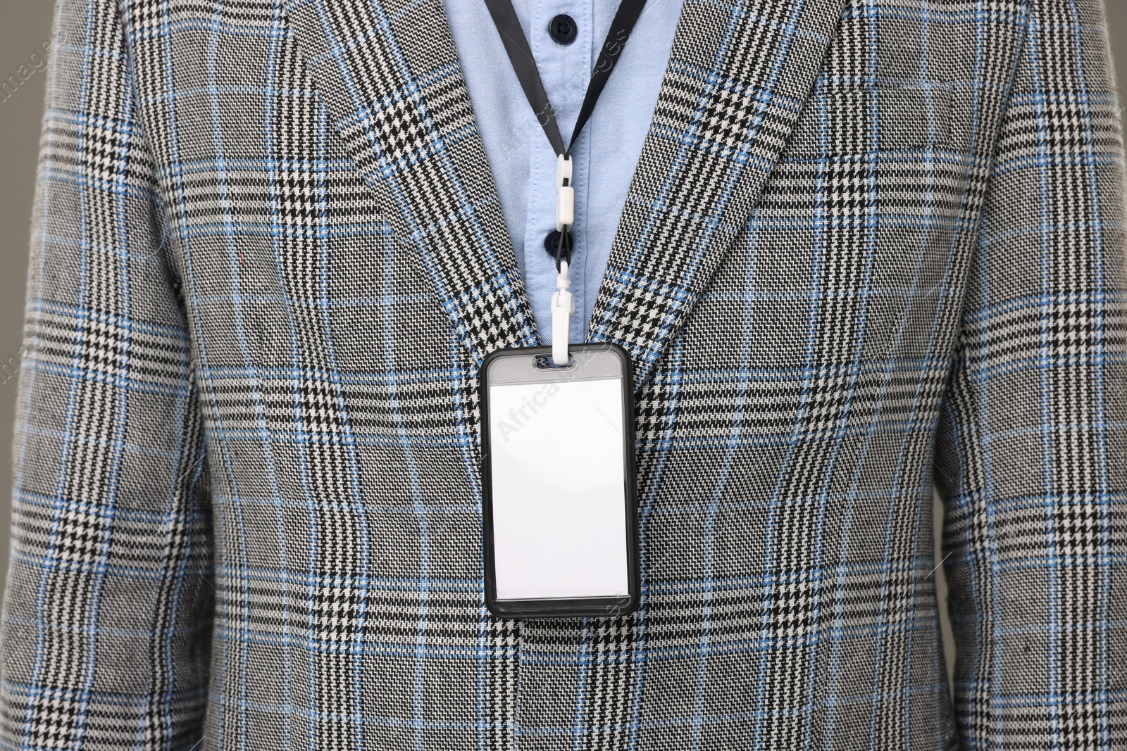 Photo of Closeup view of man with blank badge