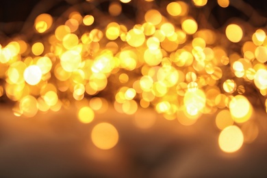 Photo of Gold glitter with bokeh effect on dark background