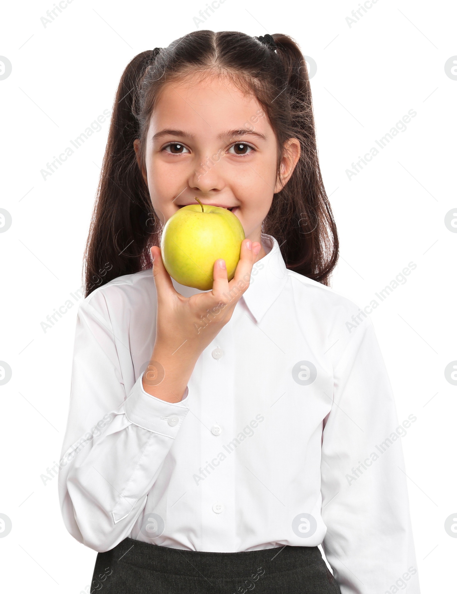 Photo of Little girl eating apple on white background. Healthy food for school lunch