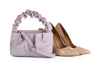 Photo of Purple women's mini bag and high heeled shoes on white background