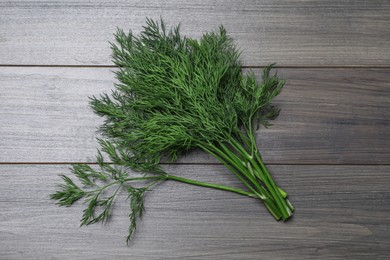 Photo of Bunch of fresh dill on wooden table, top view