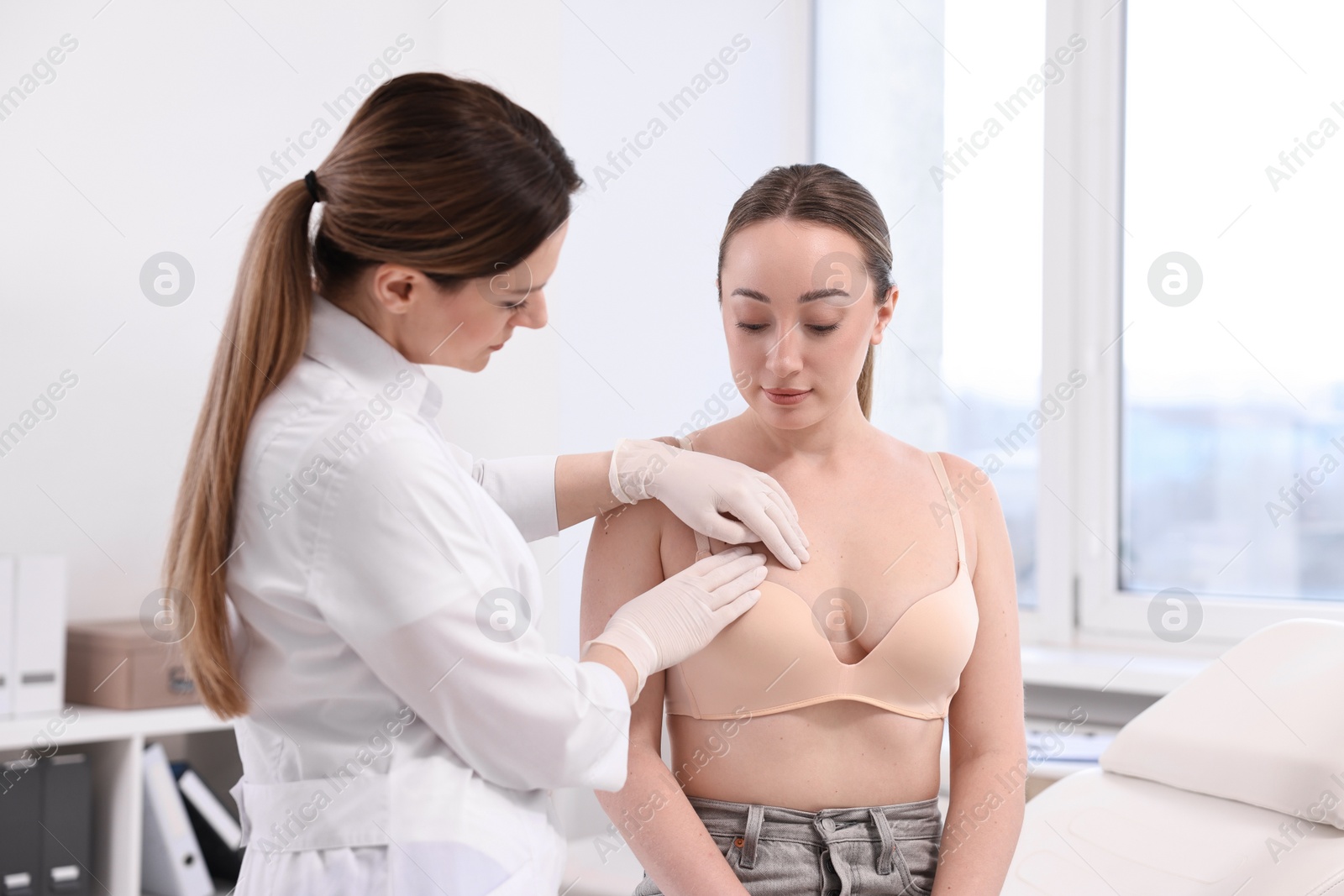 Photo of Mammologist checking young woman's breast in hospital