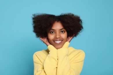 Photo of Portrait of smiling African American woman on light blue background