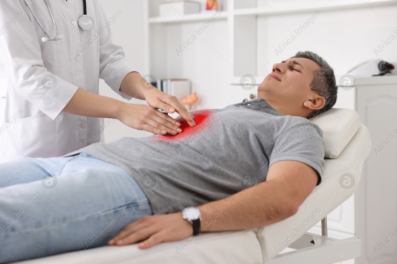 Image of Gastroenterologist examining patient with stomach pain on couch in clinic, closeup