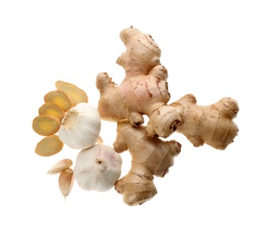 Photo of Ginger and fresh garlic on white background, top view. Natural cold remedies