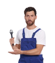 Professional plumber with adjustable wrench on white background