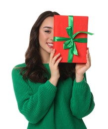 Beautiful young woman with Christmas gift isolated on white