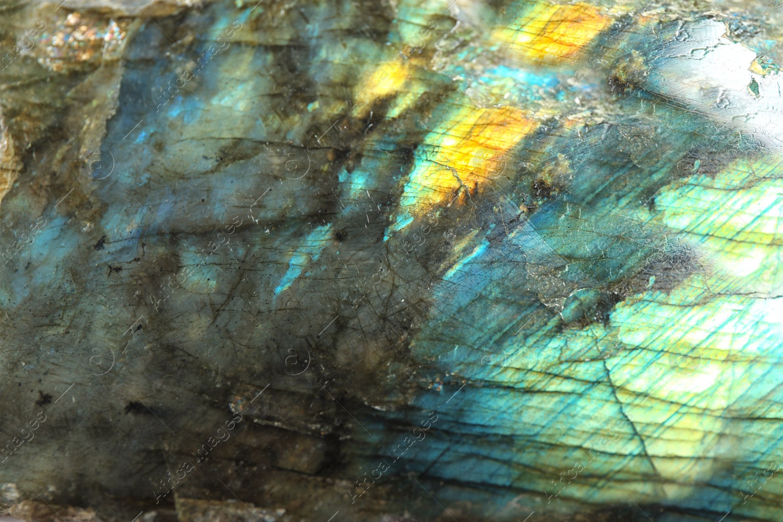 Photo of Beautiful labradorite gemstone on white background, closeup