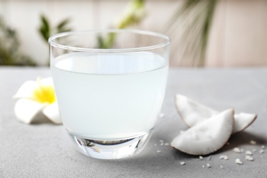Photo of Glass of coconut water on table, closeup