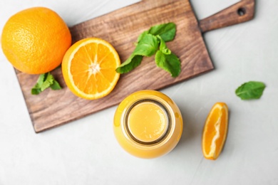 Photo of Flat lay composition with tasty juice and oranges on table