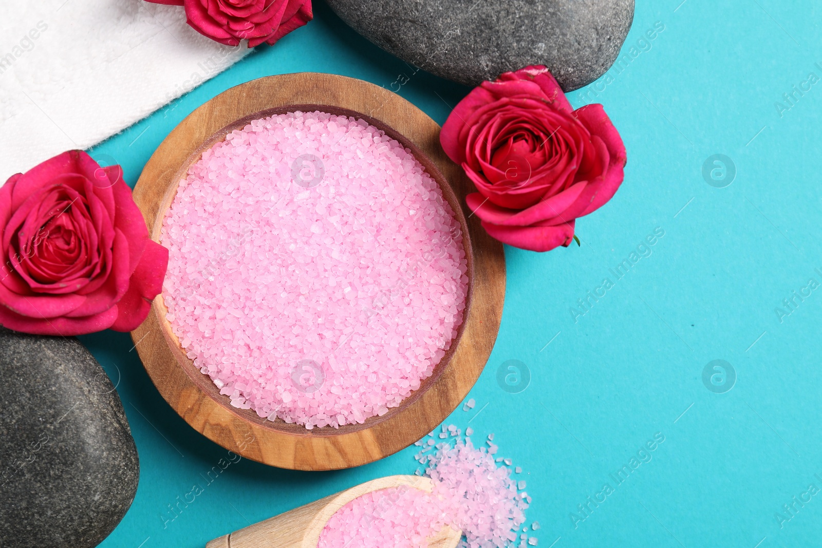 Photo of Flat lay composition with natural sea salt on light blue background. Space for text