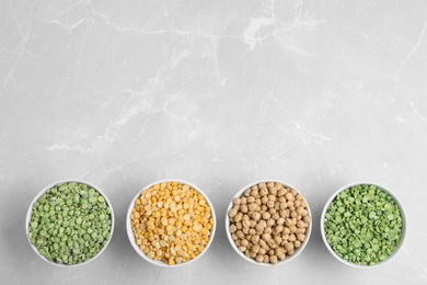 Photo of Flat lay composition with different dried peas on light background