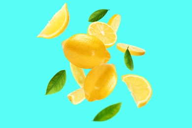 Image of Fresh ripe lemons and green leaves flying on cyan background