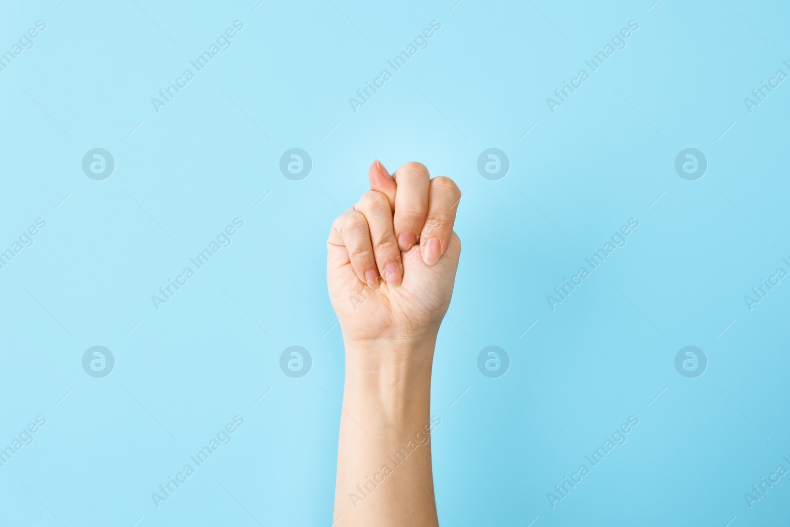 Photo of Woman showing N letter on color background, closeup. Sign language