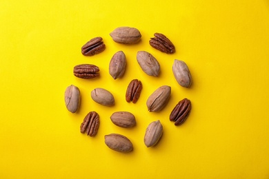 Photo of Composition with pecan nuts on color background, top view