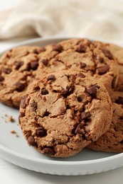 Photo of Delicious chocolate chip cookies on plate, closeup