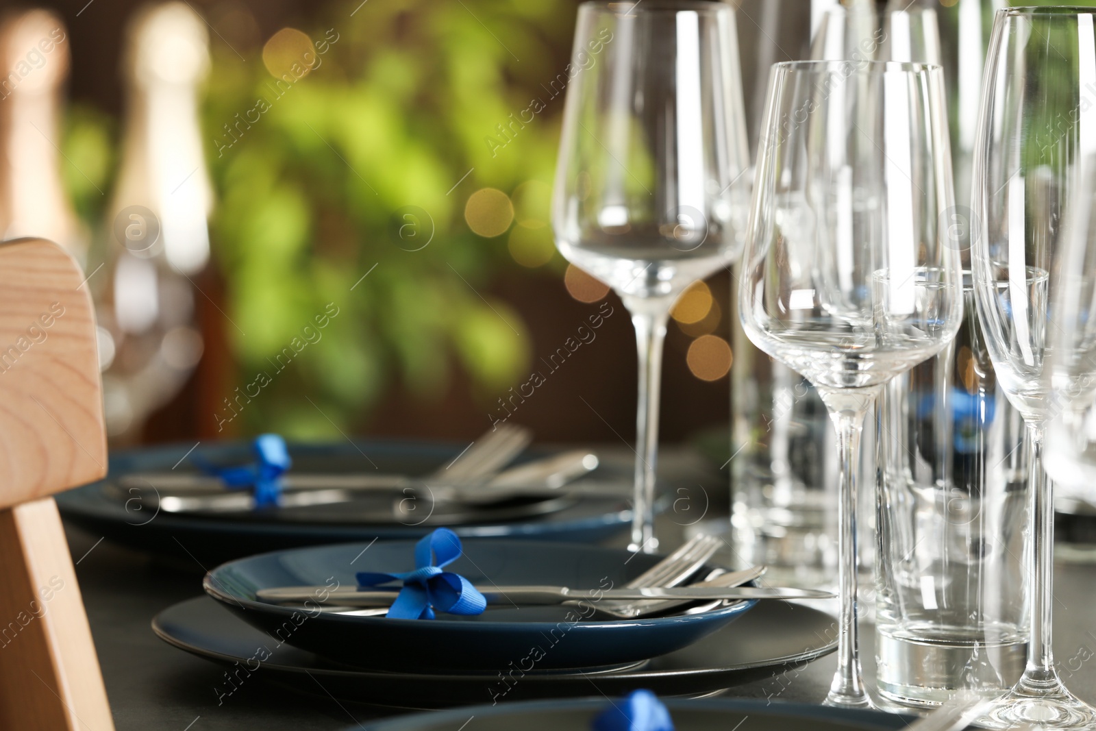 Photo of Table setting with empty glasses, plates and cutlery indoors. Space for text