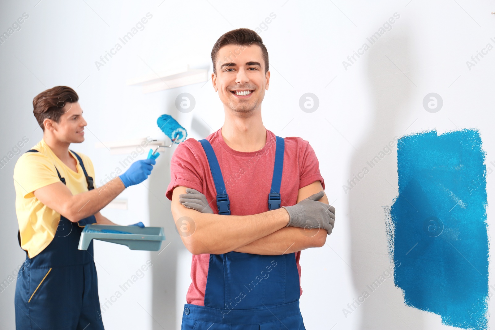 Photo of Professional decorators in uniforms indoors