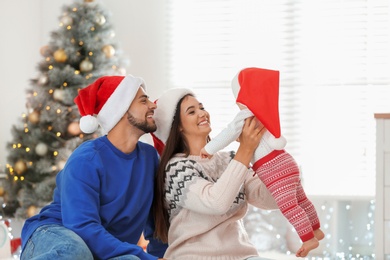 Photo of Happy family with cute baby at home. Christmas celebration