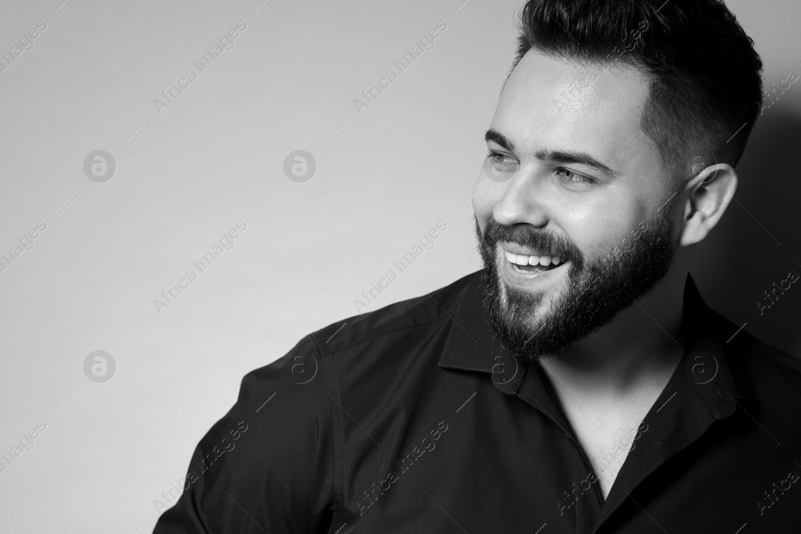 Photo of Portrait of handsome bearded man on light background. Black and white effect