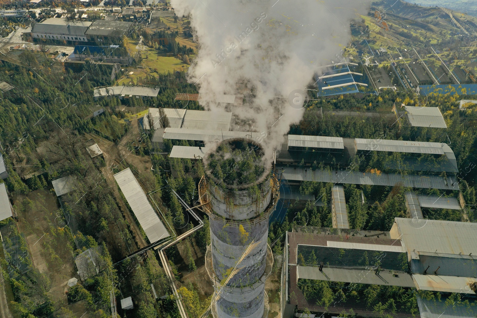 Image of Environmental pollution. Mountain landscape and industrial factory with emissions, double exposure