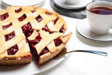 Photo of Delicious fresh cherry pie on white table, closeup