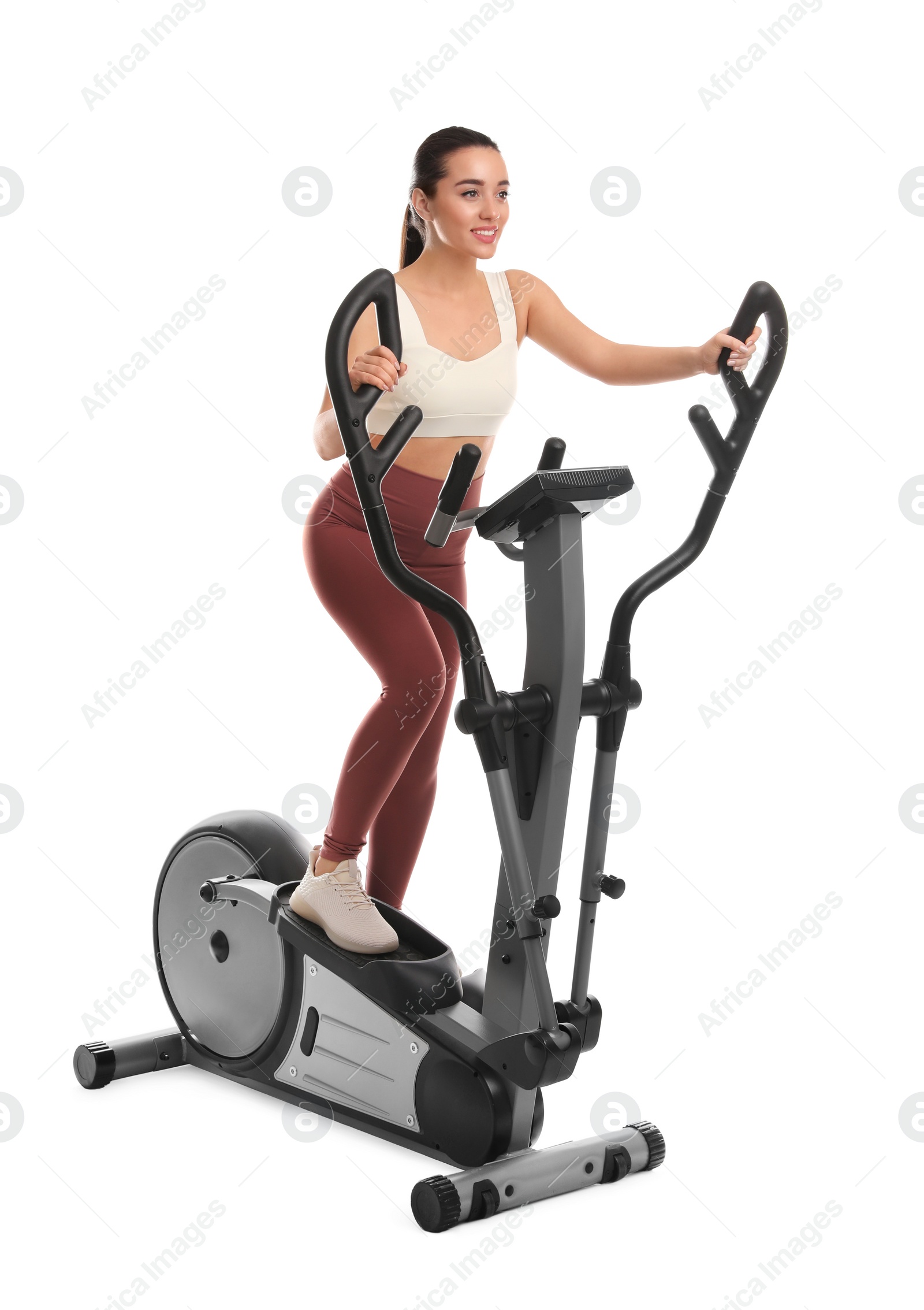 Photo of Woman using modern elliptical machine on white background