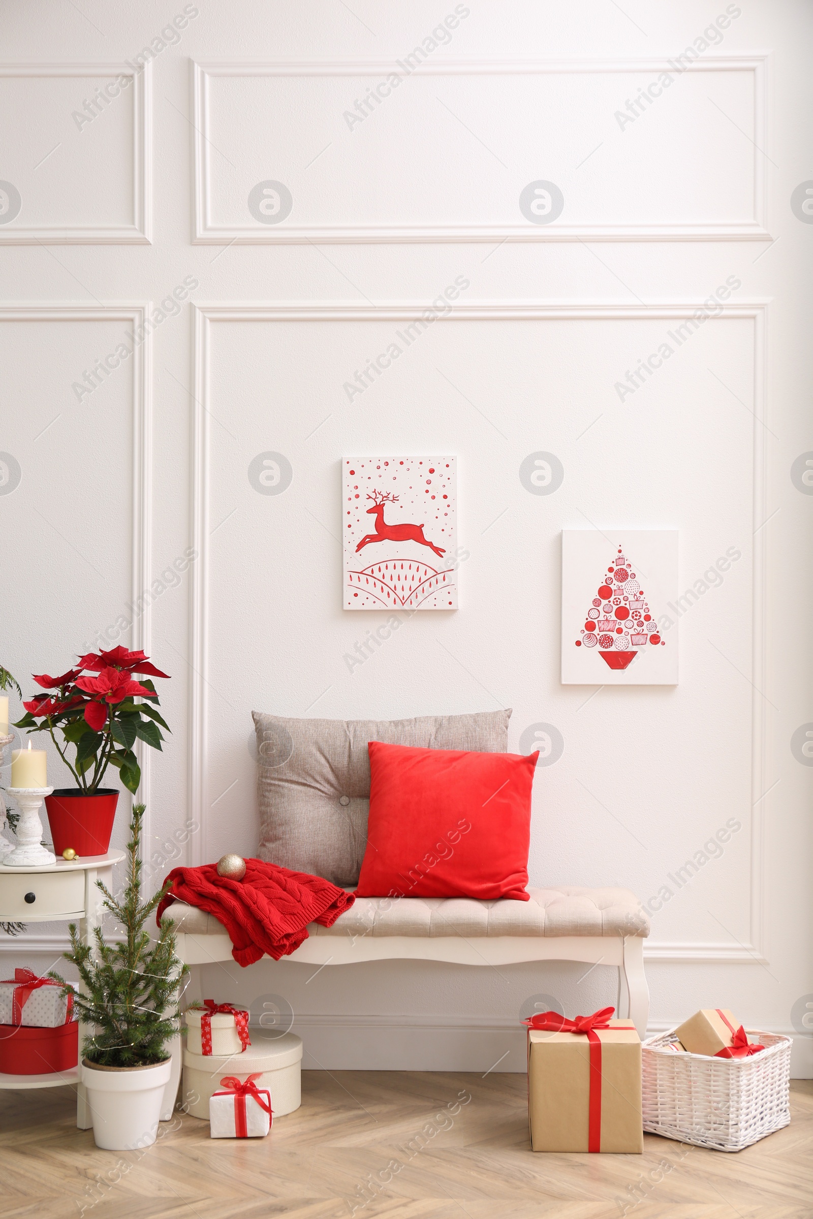 Photo of Christmas themed pictures in bright room with festive decorations. Interior design