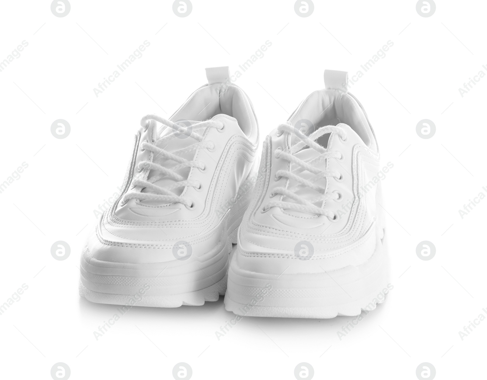 Photo of New stylish sneakers on white background. Trendy footwear