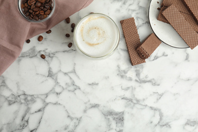 Breakfast with delicious wafers and coffee on white marble table, flat lay. Space for text