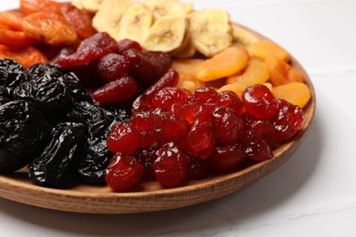 Delicious dried fruits on white table, closeup